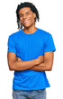 © Krakenimages.com - Young african american man wearing casual clothes happy face smiling with crossed arms looking at the camera. positive person.