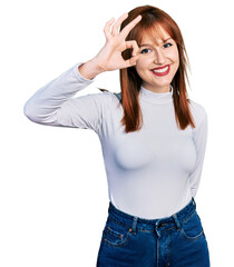 Sticker - Redhead young woman wearing casual turtleneck sweater smiling positive doing ok sign with hand and fingers. successful expression.