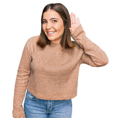 Wall Mural - Young beautiful woman wearing casual clothes smiling with hand over ear listening an hearing to rumor or gossip. deafness concept.