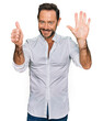 © Krakenimages.com - Middle age man wearing casual clothes showing and pointing up with fingers number six while smiling confident and happy.