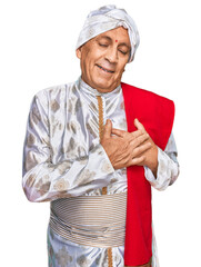 Poster - Senior hispanic man wearing tradition sherwani saree clothes smiling with hands on chest with closed eyes and grateful gesture on face. health concept.