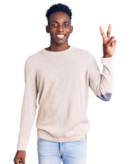 Young african american man wearing casual clothes smiling with happy face winking at the camera doing victory sign. number two.