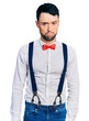 © Krakenimages.com - Hispanic man with beard wearing hipster look with bow tie and suspenders depressed and worry for distress, crying angry and afraid. sad expression.