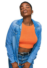 Canvas Print - Young african american woman wearing casual clothes looking at the camera blowing a kiss on air being lovely and sexy. love expression.