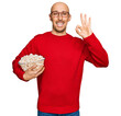 © Krakenimages.com - Bald man with beard eating popcorn doing ok sign with fingers, smiling friendly gesturing excellent symbol