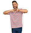 © Krakenimages.com - Handsome man with beard wearing striped tshirt smiling in love showing heart symbol and shape with hands. romantic concept.