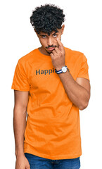 Young arab man wearing tshirt with happiness word message pointing to the eye watching you gesture, suspicious expression