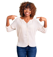 Sticker - Young african american woman wearing casual clothes looking confident with smile on face, pointing oneself with fingers proud and happy.