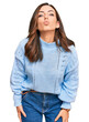 © Krakenimages.com - Young brunette woman wearing casual winter sweater looking at the camera blowing a kiss on air being lovely and sexy. love expression.
