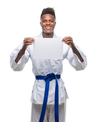 Wall Mural - Young african american man over isolated background wearing kimono holding paper with a happy face standing and smiling with a confident smile showing teeth