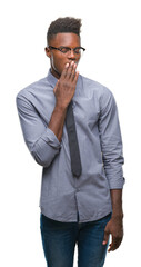 Wall Mural - Young african american business man over isolated background bored yawning tired covering mouth with hand. Restless and sleepiness.