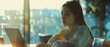 © Ai Studio - Bathed in the golden glow of sunset, a young woman focuses on her laptop, embodying a harmonious blend of productivity and tranquility.