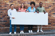 © Frank Coop/peopleimages.com - Advertising, portrait and space on poster of people outdoor on city street together with brick wall background. Business, diversity or mockup on banner for marketing with man and woman employee group