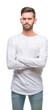 © Krakenimages.com - Young handsome man over isolated background skeptic and nervous, disapproving expression on face with crossed arms. Negative person.