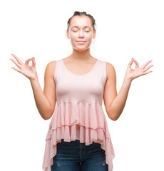 Young caucasian beautiful woman over isolated background relax and smiling with eyes closed doing meditation gesture with fingers. Yoga concept.