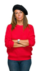 Wall Mural - middle age adult woman wearing fashion beret over isolated background with serious expression on fac