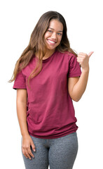 Sticker - Young beautiful brunette woman over isolated background smiling with happy face looking and pointing to the side with thumb up.