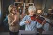© Miljan Živković - Private music teacher give violin lesson mature senior woman at home