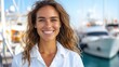 © Lens Legacy - A woman dressed in a casual white shirt stands near luxurious docked yachts on a bright, sunny day. She looks happy and relaxed, enjoying the marina surroundings.