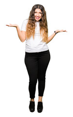 Young beautiful woman wearing casual white t-shirt Smiling showing both hands open palms, presenting and advertising comparison and balance