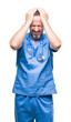 © Krakenimages.com - Middle age hoary senior doctor man wearing medical uniform over isolated background suffering from headache desperate and stressed because pain and migraine. Hands on head.