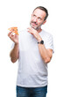 © Krakenimages.com - Middle age hoary senior man eating pizza slice over isolated background serious face thinking about question, very confused idea