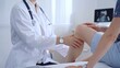 © volha_r - Doctor is carefully examining a patient's knee, providing personalized care and support. Medicine and orthopedic concept