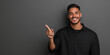 © Rapid Stock - Studio portrait of A handsome  latin man with a smile on his face pointing at an empty space wearing casual clothes isolated on a colored background for advertising or just copy space