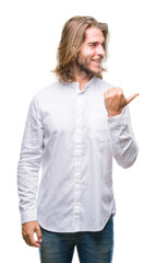 Poster - Young handsome man with long hair over isolated background smiling with happy face looking and pointing to the side with thumb up.