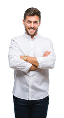 Canvas Print - Young handsome man over isolated background happy face smiling with crossed arms looking at the camera. Positive person.