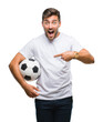 © Krakenimages.com - Young handsome man holding soccer football ball over isolated background very happy pointing with hand and finger