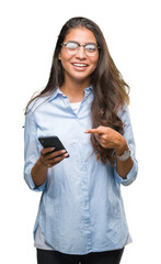 Poster - Young beautiful arab woman texting using smartphone over isolated background very happy pointing with hand and finger