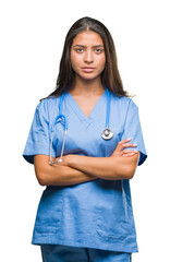 Wall Mural - Young arab doctor surgeon woman over isolated background skeptic and nervous, disapproving expression on face with crossed arms. Negative person.