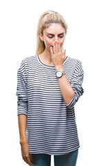 Sticker - Young beautiful blonde woman wearing stripes sweater over isolated background bored yawning tired covering mouth with hand. Restless and sleepiness.