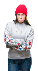 Sticker - Young caucasian beautiful woman wearing wool cap over isolated background skeptic and nervous, disapproving expression on face with crossed arms. Negative person.