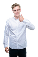 Sticker - Young handsome blond man doing happy thumbs up gesture with hand. Approving expression looking at the camera with showing success.