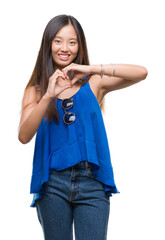 Sticker - Young asian woman over isolated background smiling in love showing heart symbol and shape with hands. Romantic concept.