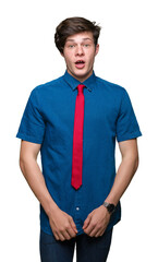 Wall Mural - Young handsome business man wearing red tie over isolated background afraid and shocked with surprise expression, fear and excited face.