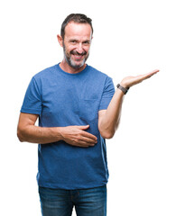 Wall Mural - Middle age hoary senior man over isolated background smiling cheerful presenting and pointing with palm of hand looking at the camera.