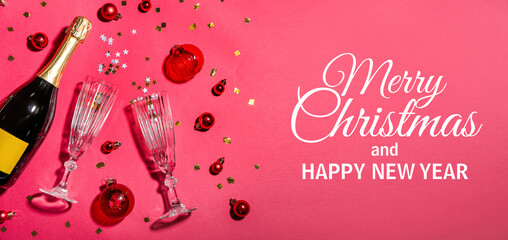 Wall Mural - Bottle of champagne with glasses, Christmas balls and confetti on pink background