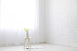 © Pixel-Shot - Coffee table with flowers and light curtains in white room
