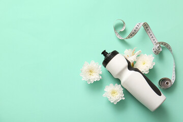 Wall Mural - Composition with sports water bottle, measuring tape and flowers on color background