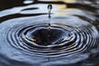 © arhendrix - Close-up of a water droplet creating ripples on a smooth surface, demonstrating the fluid dynamics and patterns of water movement.
