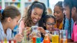 © Daria Lukoiko - Group of happy female students and their teacher are doing a chemistry experiment in school. They are smiling and looking at the results of their experiment