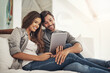 © Sanc/peopleimages.com - Video call, happy and couple on tablet in bedroom for conversation, online chat and relax in home. Communication, dating and man and woman for social networking, talking and contact with tech