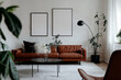 © Roman - Two blank vertical din A posters with black frames in scandinavian style living room interior design. Frame mockups on a white wall, black floor lamp, brown leather sofa, coffee table, potted plants