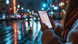 © pornsawan - Young woman holding a smartphone with an open online maps app in city street. The concept of online navigators and applications for smartphones,Close up,Blurred night light city background.