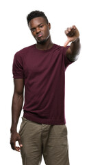 Poster - Young african american man with angry face, negative sign showing dislike with thumbs down, rejection concept