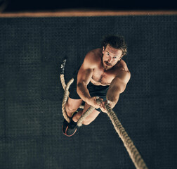 Canvas Print - Body, fitness and rope climbing with man in gym from above for challenge, performance or workout. Exercise, target and wellness with serious climber in health club for physical or strength training