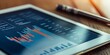 © kwanchaift - Close-up of a meeting agenda on a tablet with financial charts, highlighting a structured approach to business discussions and planning